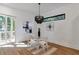 Bright dining area with modern chandelier, abstract art, and sliding glass door to deck at 1464 Ezra Church Nw Dr, Atlanta, GA 30314