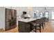 Modern kitchen with stainless steel appliances, gray island seating, and open floor plan at 1464 Ezra Church Nw Dr, Atlanta, GA 30314