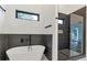 Modern bathroom with freestanding tub, tiled shower, and sleek fixtures at 1464 Ezra Church Nw Dr, Atlanta, GA 30314