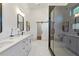 Luxury bathroom featuring double vanity, modern mirrors, and glass-enclosed shower at 1464 Ezra Church Nw Dr, Atlanta, GA 30314