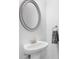 Elegant white bathroom sink with brushed nickel faucet and modern oval mirror at 2133 Kirkham Way, Kennesaw, GA 30152