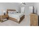 Main bedroom with a wood bed frame, ceiling fan, and carpeted floors at 2133 Kirkham Way, Kennesaw, GA 30152