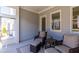 Comfortable screened porch with wicker seating, footstools, and view of backyard at 2133 Kirkham Way, Kennesaw, GA 30152