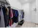 Bright walk-in closet featuring organized storage with shelving, hanging rods, and shoe racks for optimal organization at 2133 Kirkham Way, Kennesaw, GA 30152