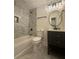 Modern bathroom features sleek vanity, black fixtures, and a tub/shower combo with stunning marble-style tile surround at 2228 Carey Se Dr, Atlanta, GA 30315