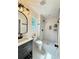 Contemporary bathroom with a single vanity, decorative lighting, and a tiled shower at 2228 Carey Se Dr, Atlanta, GA 30315