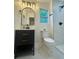 Modern bathroom features sleek vanity, black fixtures, and a separate shower with stunning marble-style tile surround at 2228 Carey Se Dr, Atlanta, GA 30315