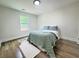 Bright bedroom with a comfortable bed, wood floor, and a view of the yard at 2228 Carey Se Dr, Atlanta, GA 30315