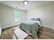 Cozy bedroom filled with natural light, featuring hardwood floors and a comfortable bed with soft, attractive bedding at 2228 Carey Se Dr, Atlanta, GA 30315