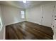 Bedroom features hardwood floors, baseboard trim and a window view to the outdoors at 2228 Carey Se Dr, Atlanta, GA 30315
