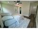 Bright bedroom features a ceiling fan, wood floors, and large area rug at 2228 Carey Se Dr, Atlanta, GA 30315