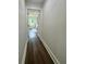 Hallway provides access to the bedrooms and features wide plank wood flooring at 2228 Carey Se Dr, Atlanta, GA 30315