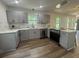 Modern kitchen with gray cabinets, stainless steel appliances, and updated fixtures at 2228 Carey Se Dr, Atlanta, GA 30315