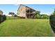 Expansive backyard featuring lush green grass, a wooden deck, and a black metal fence at 2330 Cheatham Creek Ct, Cumming, GA 30040