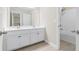 Bright bathroom featuring a double sink vanity and shower over tub with tiled walls at 2330 Cheatham Creek Ct, Cumming, GA 30040