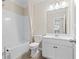 Bright bathroom featuring a shower over tub and a single sink vanity with storage at 2330 Cheatham Creek Ct, Cumming, GA 30040