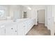 A bright bathroom offers double sinks, a vanity with a large mirror, and stylish tile flooring at 2330 Cheatham Creek Ct, Cumming, GA 30040