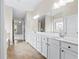 A well-lit bathroom boasts double sinks, a soaking tub, and a separate shower, offering a spa-like experience at 2330 Cheatham Creek Ct, Cumming, GA 30040