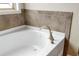 Close-up of a modern bathtub with stylish fixtures and neutral tile surround, creating a relaxing ambiance at 2330 Cheatham Creek Ct, Cumming, GA 30040