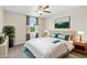 Comfortable staged bedroom featuring a large window and ceiling fan for ample light and air flow at 2330 Cheatham Creek Ct, Cumming, GA 30040