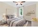 A charming bedroom is staged with modern decor, a cozy bed, and ample natural light, creating a comfortable space at 2330 Cheatham Creek Ct, Cumming, GA 30040