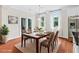 Staged dining area with a modern table, seating for six, natural light, and sliding doors to the outside at 2330 Cheatham Creek Ct, Cumming, GA 30040