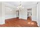 Dining room featuring hardwood floors, wainscoting, and a stylish chandelier over a dark wood table at 2330 Cheatham Creek Ct, Cumming, GA 30040