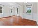 Dining room featuring hardwood floors, wainscoting, white trim, and natural light from large windows at 2330 Cheatham Creek Ct, Cumming, GA 30040