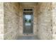 Front door with glass panel and sidelights framed by a light-colored brick facade at 2330 Cheatham Creek Ct, Cumming, GA 30040