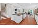 Spacious kitchen shows an island with granite countertop, and open access to the living and dining areas at 2330 Cheatham Creek Ct, Cumming, GA 30040