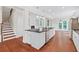 Kitchen with island featuring stone countertop, stainless steel appliances and a staircase at 2330 Cheatham Creek Ct, Cumming, GA 30040