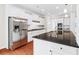 A stainless steel refrigerator stands next to granite counters and an island at 2330 Cheatham Creek Ct, Cumming, GA 30040