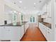Bright kitchen features white cabinetry, a large island with black countertops, and stainless steel appliances at 2330 Cheatham Creek Ct, Cumming, GA 30040
