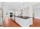 Bright kitchen featuring a central island with granite countertops, stainless steel appliances and hardwood flooring at 2330 Cheatham Creek Ct, Cumming, GA 30040