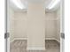 A spacious walk-in closet offers ample storage with built-in shelving and neutral carpeting at 2330 Cheatham Creek Ct, Cumming, GA 30040