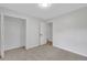 Carpeted bedroom features a closet and an open door way to another room at 25 Carriage Ct, Stockbridge, GA 30281