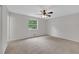 Large bedroom features neutral carpeting, a ceiling fan, and lots of natural light at 25 Carriage Ct, Stockbridge, GA 30281