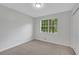 Neutral bedroom with a window providing natural light and a closet for storage, creating a serene retreat at 25 Carriage Ct, Stockbridge, GA 30281