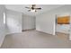 Spacious bedroom features neutral carpeting and paint and an open door to another room at 25 Carriage Ct, Stockbridge, GA 30281