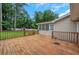 Large wooden deck offers ample outdoor living space, perfect for entertaining, with backyard and wooded views at 25 Carriage Ct, Stockbridge, GA 30281