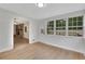 Bright dining room with laminate flooring, large windows, and a stylish light fixture, perfect for Gathering meals at 25 Carriage Ct, Stockbridge, GA 30281