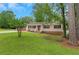 Well-maintained home with green lawn, mature trees, and welcoming front porch, offering great curb appeal at 25 Carriage Ct, Stockbridge, GA 30281