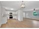 Modern white kitchen with stainless steel appliances, stylish light fixtures, and plenty of cabinet space at 25 Carriage Ct, Stockbridge, GA 30281