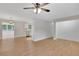 Bright and airy living room with laminate floors, neutral walls, and modern ceiling fan for comfortable living at 25 Carriage Ct, Stockbridge, GA 30281