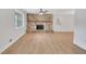 Spacious living area with a stone fireplace, ceiling fan, neutral walls, and natural light from the large window at 25 Carriage Ct, Stockbridge, GA 30281