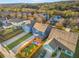 An aerial view of a neighborhood showcasing well-maintained homes with a backdrop of lush greenery and a bright blue sky at 3210 Ancoats St, Douglasville, GA 30135
