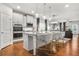 Modern open-concept kitchen with stainless steel appliances, a center island, and seamless flow to the living area at 3210 Ancoats St, Douglasville, GA 30135