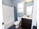 This bathroom features a tub with shower, toilet, and vanity with dark cabinets at 4560 Buckskin Way, Douglasville, GA 30135