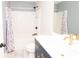 Bathroom featuring a navy vanity with gold hardware, floral shower curtain, and wood look tile floor at 4560 Buckskin Way, Douglasville, GA 30135