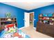 Blue ' room featuring a decorated dresser with toys and a view to an adjacent room at 4560 Buckskin Way, Douglasville, GA 30135